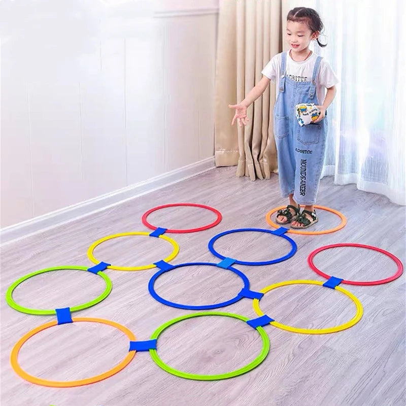 Child playing with colourful jump ring game set indoors