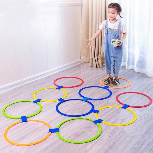 Child playing with colourful jump ring game set indoors