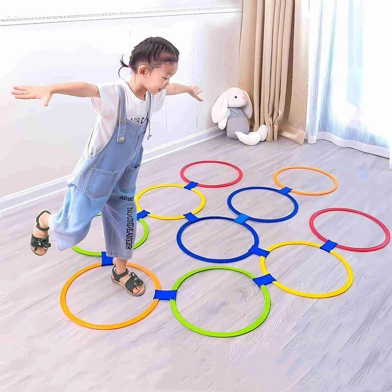 Child playing with colourful jump ring game set indoors