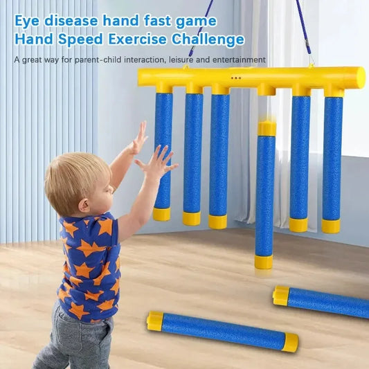 Child playing reaction training falling sticks game indoors