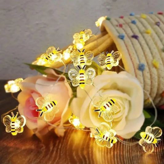 String lights shaped like bees on flowers with a textured background