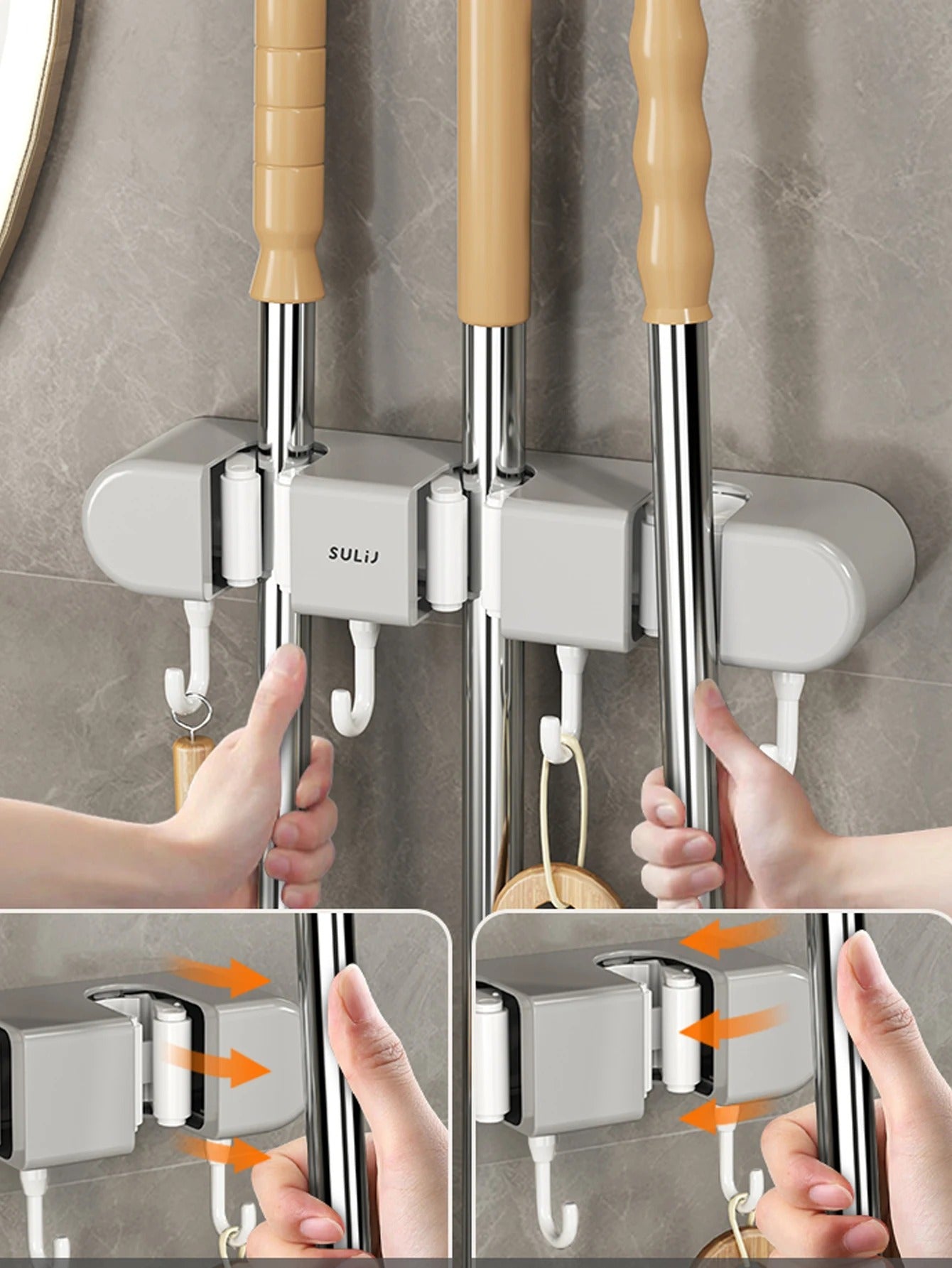 Mop and broom holder with hooks on a gray wall, showing hands using the holder.
